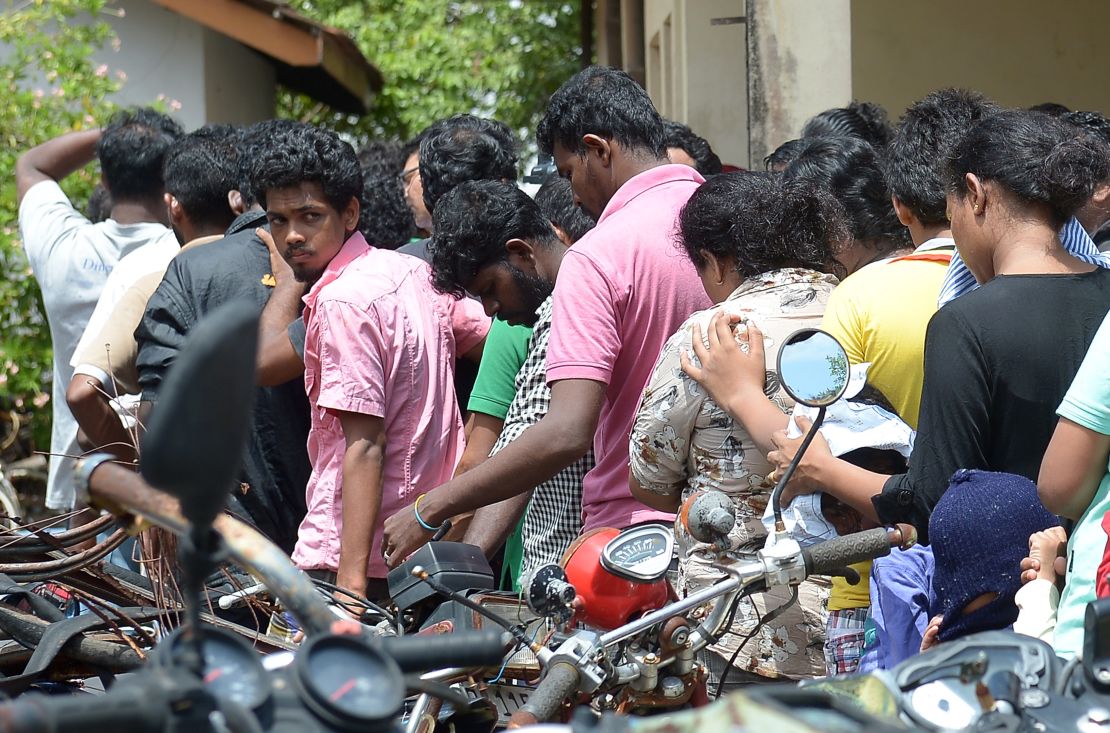 Sri Lankan asylum seekers sent back by Australia outside the magistrate's court in Galle, July 8, 2014. 