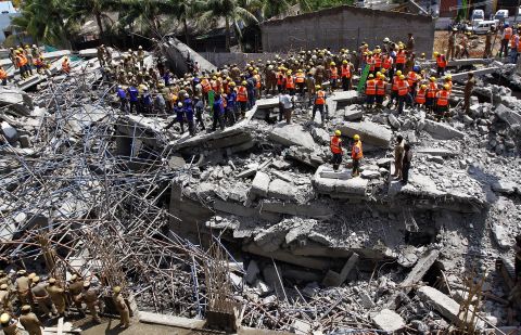 On the same day as the New Delhi building collapse, an eleven-floor building under construction came crashing down in the southern Indian city of Chennai, killing 61 workers. Workers are pictured clearing the scene on June 30.