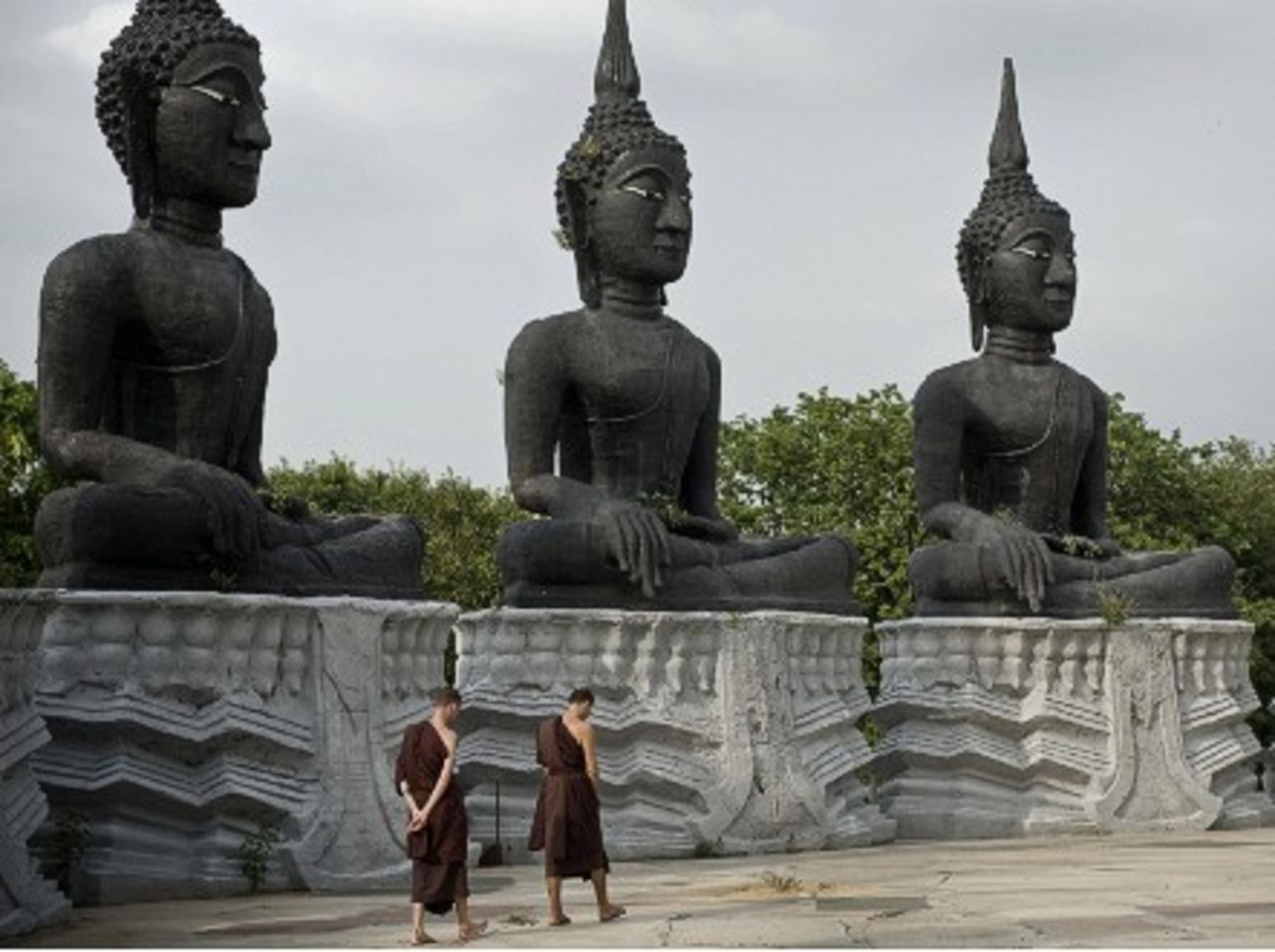 Buddhist monks practice walking meditation at the Thamkrabok monastery in Phraputthabat, Thailand.