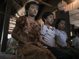 Girls meditating at a Buddhist monastic school in Myanmar.