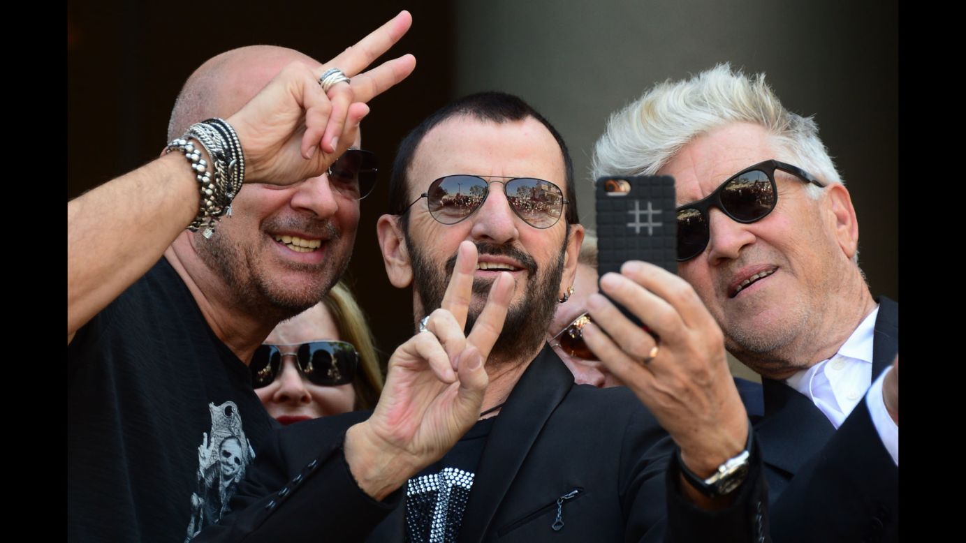 Ringo Starr, the former drummer of the Beatles, takes a selfie Monday, July 7, with fashion designer John Varvatos, left, and film director David Lynch, right. Behind them is Starr's wife, Barbara Bach. They were in Hollywood celebrating Starr's 74th birthday and the launch of a charitable initiative benefiting the Ringo Starr Peace & Love Fund.