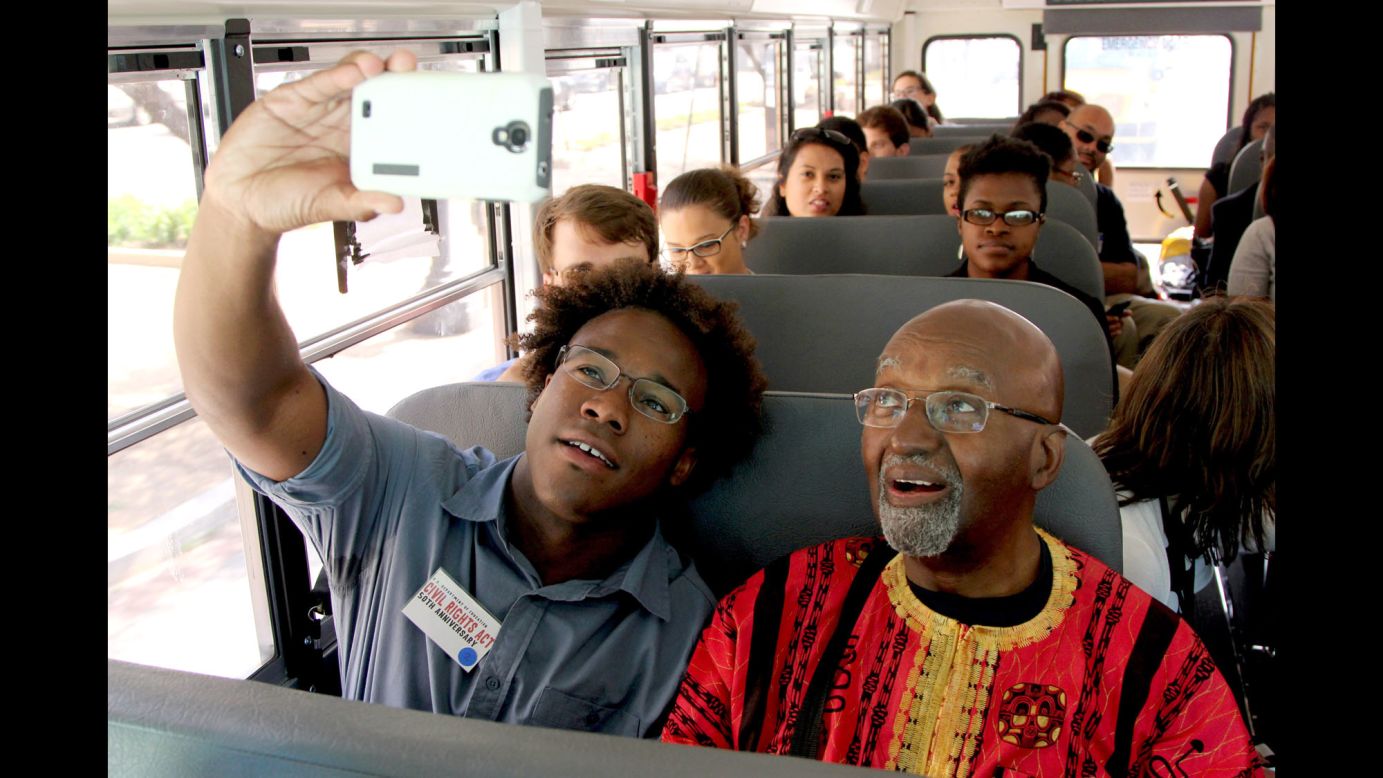 Former "Freedom Rider" John Moody, right, and college student Dennis Johnson ride through Washington on Wednesday, July 2, to commemorate the 50th anniversary of the signing of the Civil Rights Act. The Freedom Riders were an interracial group of civil rights activists who risked their lives by riding passenger buses together through the segregated Deep South.