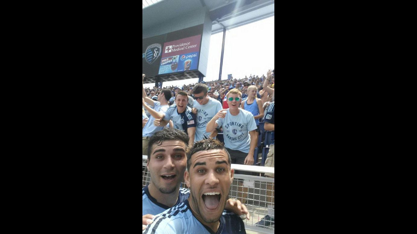 Dom Dwyer, a forward on Sporting Kansas City, <a href="https://twitter.com/SportingKC/status/485875566159994880" target="_blank" target="_blank">takes a selfie</a> with fans and teammate Soony Saad, left, after scoring a goal Sunday, July 6, in a Major League Soccer match against the Chicago Fire. He got a yellow card, however, for the cell phone celebration. The game ended in a 1-1 draw.