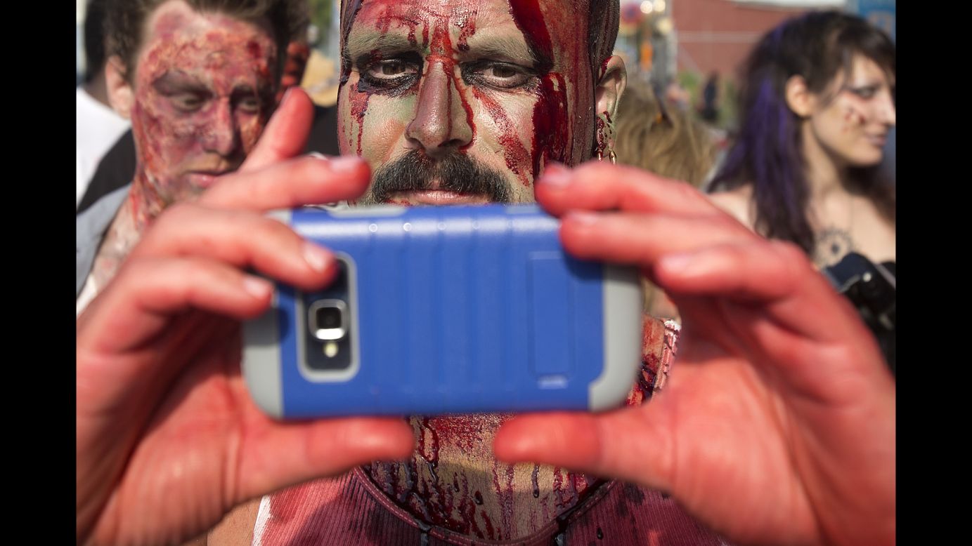 A participant of the "Zombie Takeover of Coney Island" takes a selfie as he walks in the Brooklyn, New York, neighborhood on Wednesday, July 2.