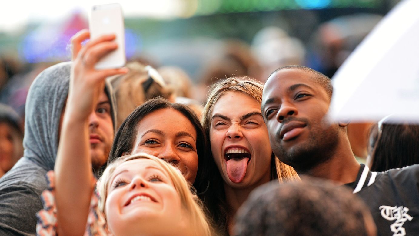 Model Cara Delevingne sticks her tongue out as she takes a selfie with fans Sunday, July 6, at the British Summer Time festival in London. <a href="http://www.cnn.com/2014/07/02/world/gallery/look-at-me-0702/index.html">See 21 selfies from last week</a>