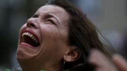 A Brazilian soccer fan cries as she watches a live telecast of the semifinals World Cup soccer match between Brazil and Germany in Belo Horizonte, Brazil, Tuesday, July 08, 2014. (AP Photo/Bruno Magalhaes)
