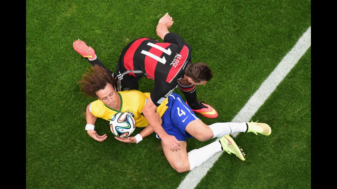 Klose and David Luiz compete for the ball.