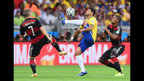 Hulk shields the ball from Schweinsteiger and German defender Jerome Boateng.