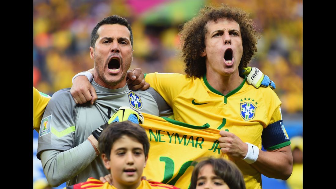 Julio Cesar, left, and David Luiz hold a Neymar jersey as they sing the national anthem prior to kickoff. Neymar was injured in the quarterfinals and couldn't continue to play in the tournament.