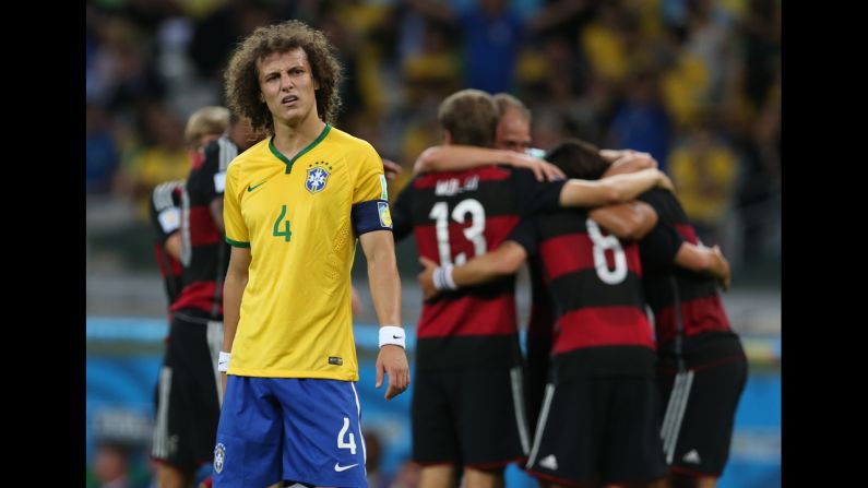 Brazil's David Luiz stands near a group of German players as they celebrate their fifth goal. Germany led 5-0 at halftime.