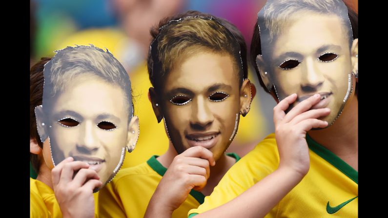 Fans wear masks of Neymar's face prior to the match. <a href="index.php?page=&url=http%3A%2F%2Fwww.cnn.com%2F2014%2F07%2F05%2Ffootball%2Fgallery%2Fwc-best-0705%2Findex.html">See the best World Cup photos from July 5</a>