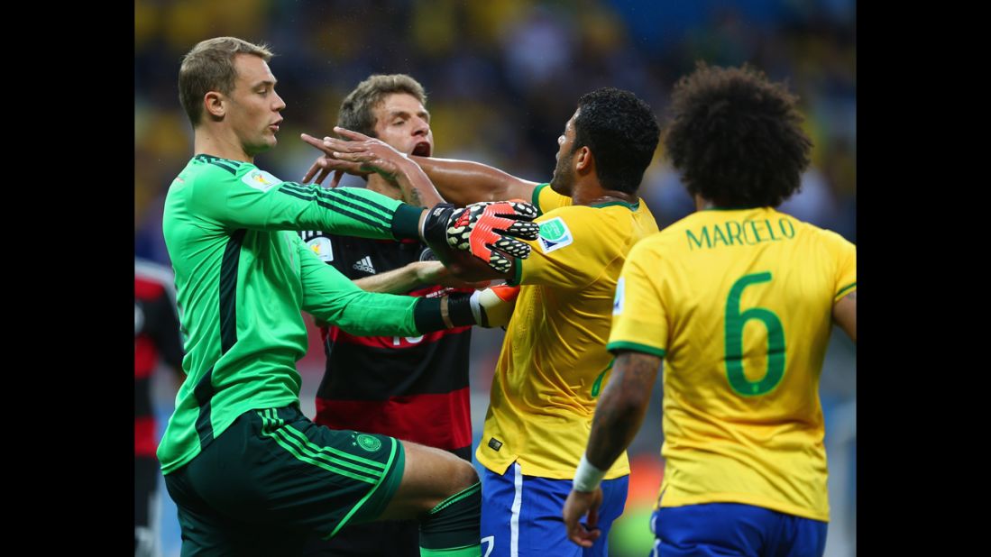 Neuer, left, separates Thomas Mueller of Germany and Hulk of Brazil.