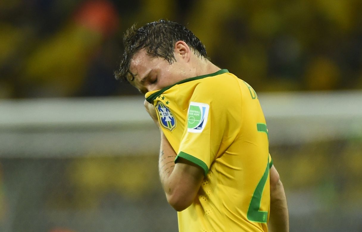 Brazil's Bernard wipes his face during the match.