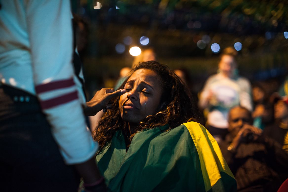 A fan wipes another fan's tears in the streets of Sao Paulo, Brazil.