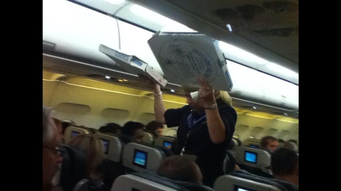 Passengers got a pizza surprise after their flight was grounded for two hours.