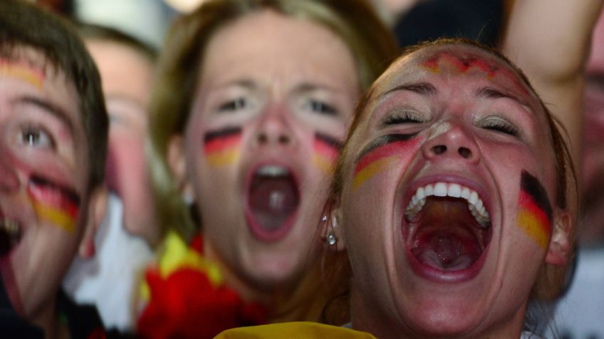 Germany fans celebrate Germany's seventh goal during the FIFA World Cup 2014 semi final football match between Brazil and Germany during a public viewing at the Brandenburg Gate in Berlin on July 8, 2014.  AFP PHOTO / JOHN MACDOUGALL        (Photo credit should read )