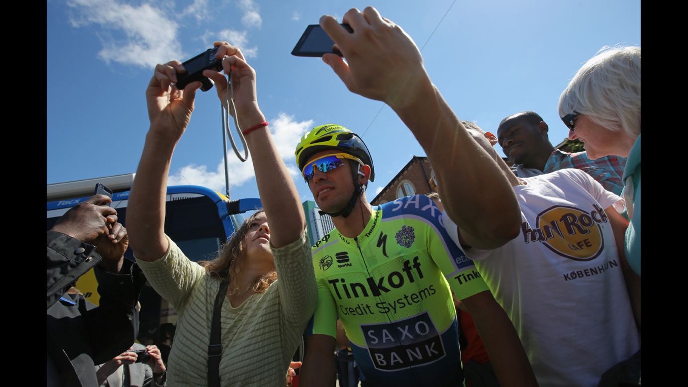 Cyclist Alberto Contador pauses for a photo with fans in Leeds, England, before the start of the Tour de France on Saturday, July 5.
