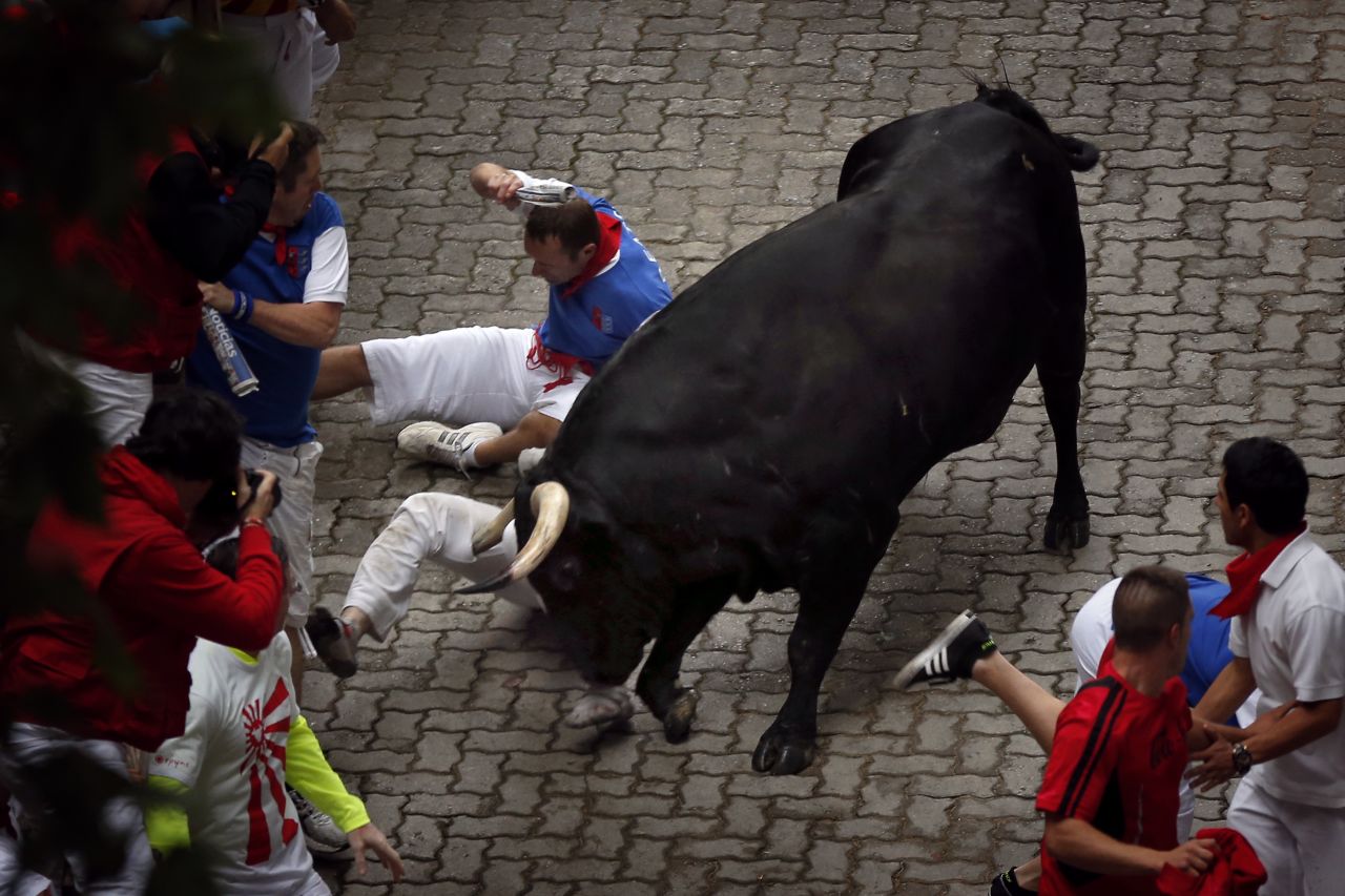 Bill Hillmann, of Chicago, <a href="http://www.cnn.com/2014/07/09/world/gallery/american-gored/index.html">is gored on his right leg</a> by a bull on July 9. Hillmann has been running in Pamplona for about a decade, and he recently co-authored a book entitled "Fiesta, How to Survive the Bulls of Pamplona."