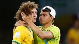 Brazil's defender Thiago Silva (R) conforts Brazil's defender David Luiz after the semi-final football match between Brazil and Germany at The Mineirao Stadium in Belo Horizonte during the 2014 FIFA World Cup on July 8, 2014. AFP PHOTO / ADRIAN DENNIS