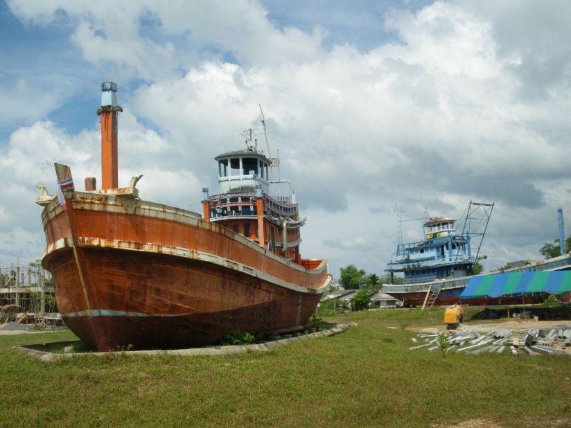 In the village of Ban Nam Khem, almost completely annihilated in the 2004 tsumani, two fishing trawlers have been left in an empty lot a kilometer inland to commemorate the 6,000 victims in Thailand.  