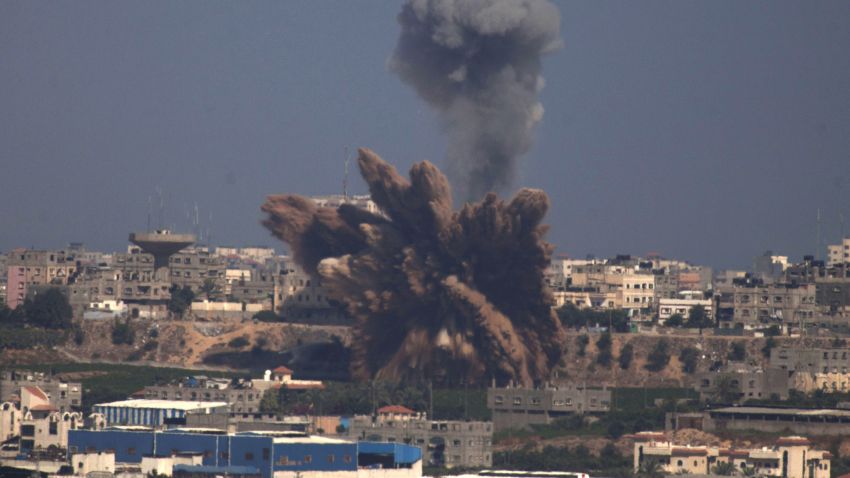 A plume of smoke rises over Gaza following an Israel Air Force bombing, as seen from near Sderot, Israel, on July 9, 2014.