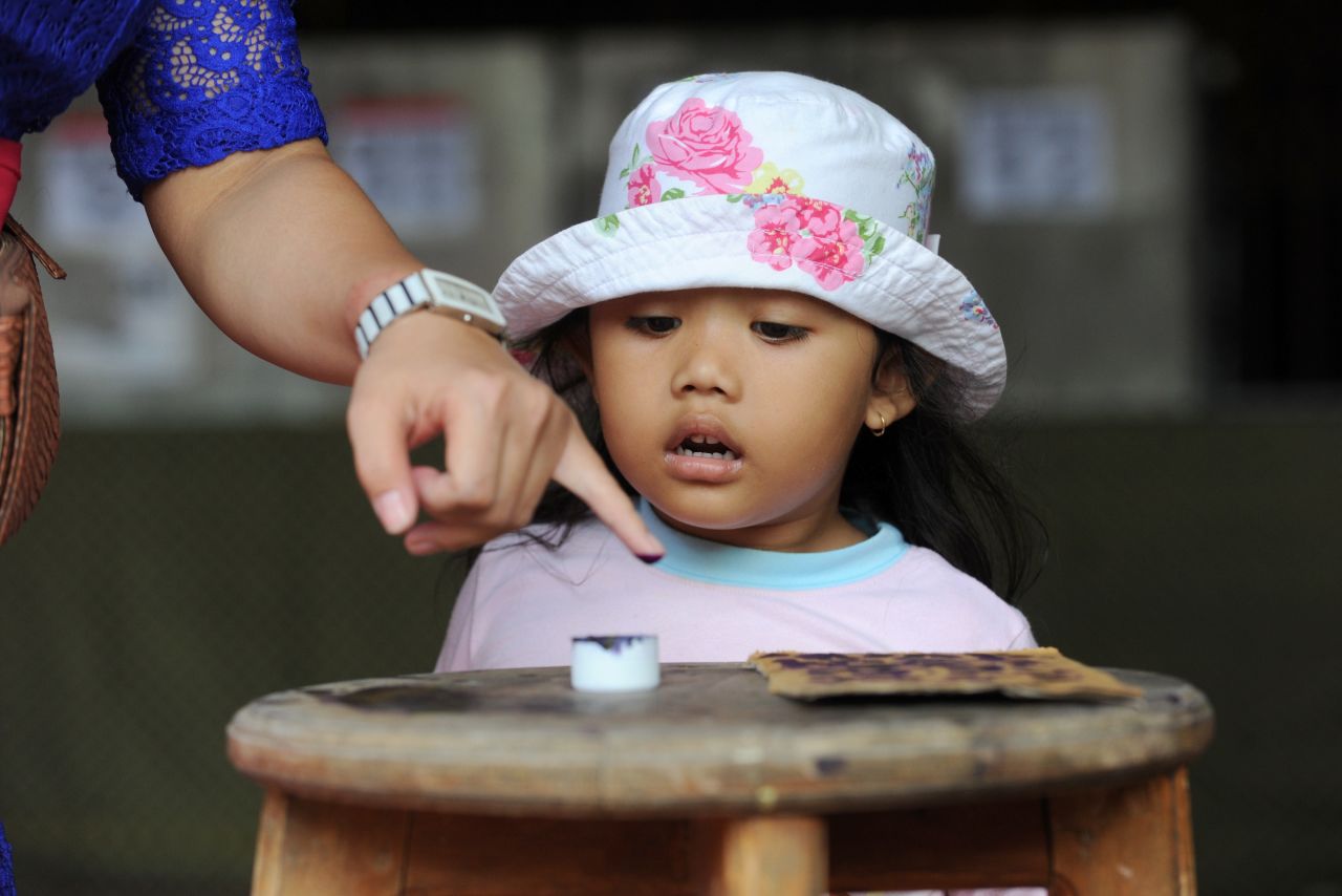 A Balinese woman inks her finger after voting in the presidential election in Bali on July 9.