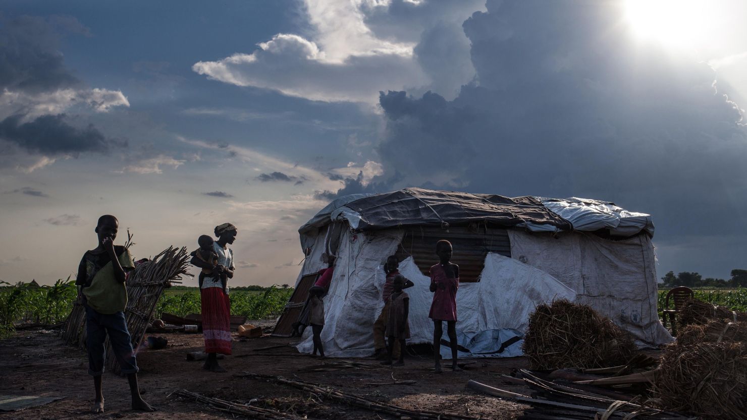 Martha Nyarueni carries one of her children outside her home near the town of Leer, South Sudan, on July 5, 2014.