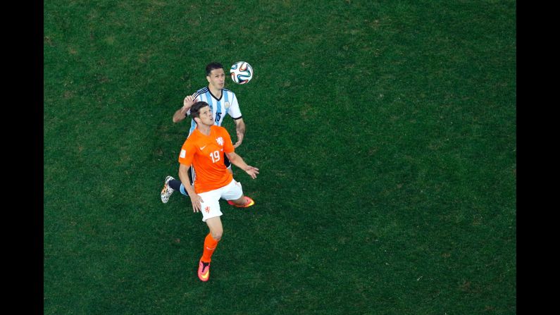Klaas-Jan Huntelaar of the Netherlands controls the ball against Martin Demichelis of Argentina.