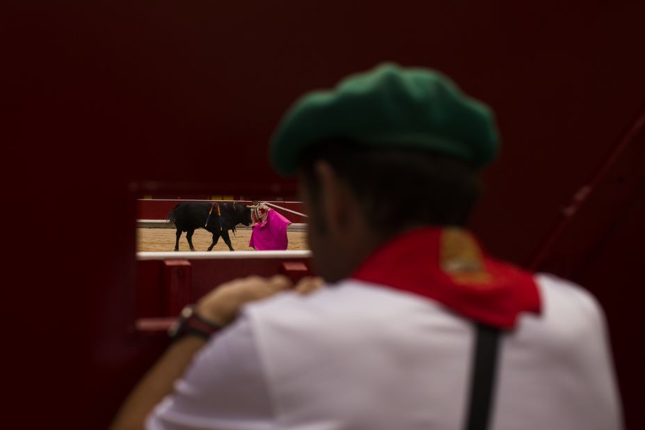 A worker watches a bullfight on July 8.