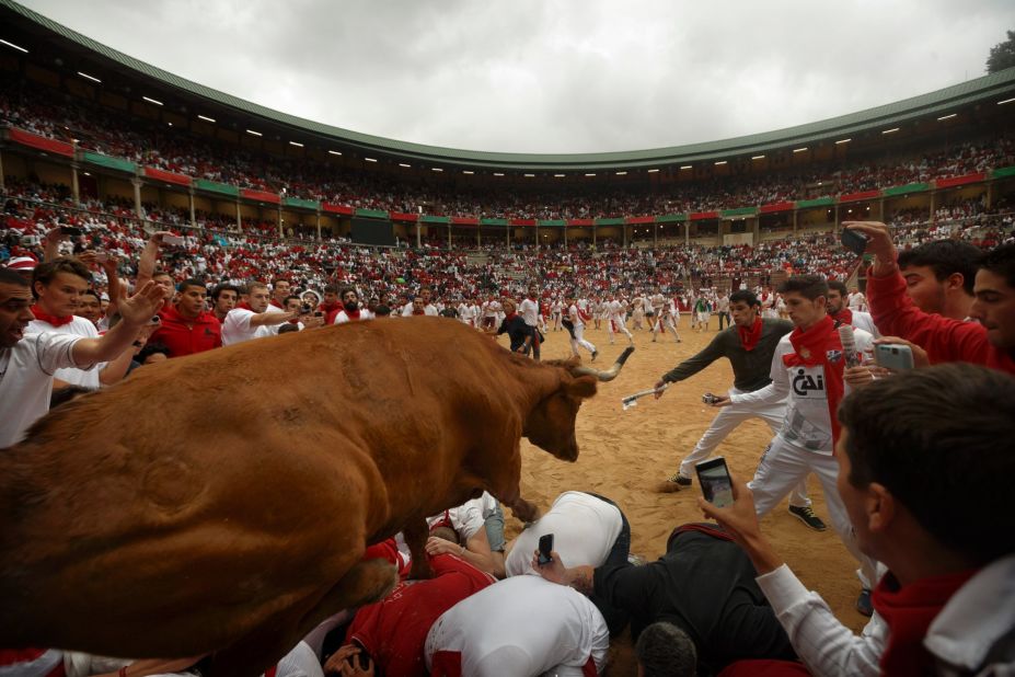 A cow jumps over revelers on July 9.