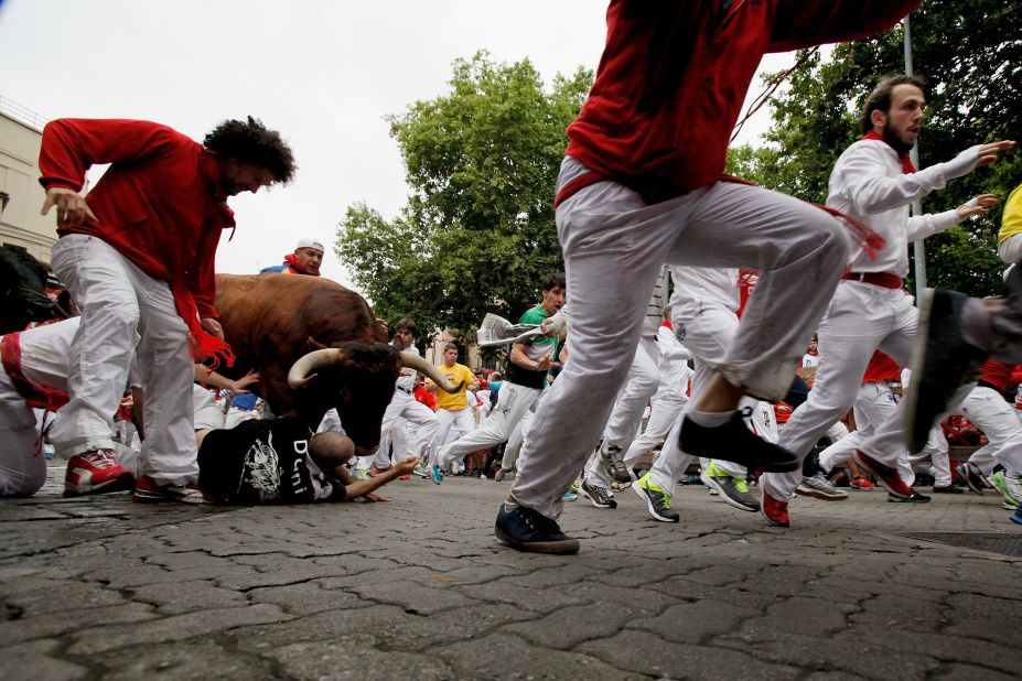 A bull jumps over revelers near the end of the run on July 9.