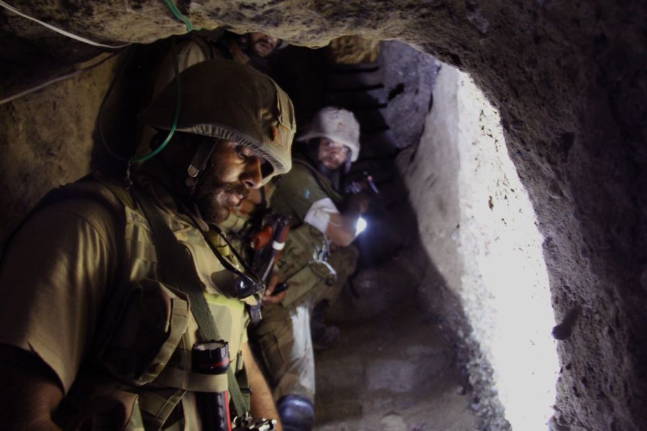 Pakistan army troops drop down into a the basement of a compound they believe was used by militants in a town in North Waziristan, where a massive ground offensive by the military has been taking place.