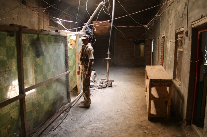A soldier inspects the inside of a compound in Miranshah, which the army believes was used by militant fighters.