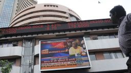 An Indian man watches the share prices ticker alongside a digital broadcast of Indian Finance Minister Arun Jaitley delivering his Budget speech at the Parliament in New Delhi, on a screen outside the Bombay Stock Exchange (BSE) in Mumbai on July 10, 2014. Jaitley set a fiscal deficit target for 2014 of 4.1 percent of GDP as he presented the new government's first budget, while promising cuts in the next few years. AFP PHOTO/ Indranil MUKHERJEEINDRANIL MUKHERJEE/AFP/Getty Images