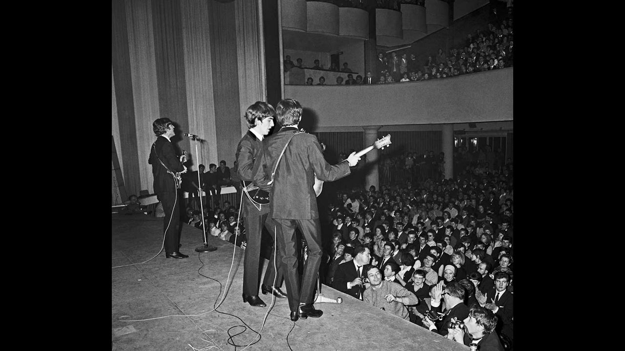 The Beatles perform on stage in Paris in 1964.