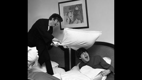 John Lennon hits McCartney with a pillow in 1964.