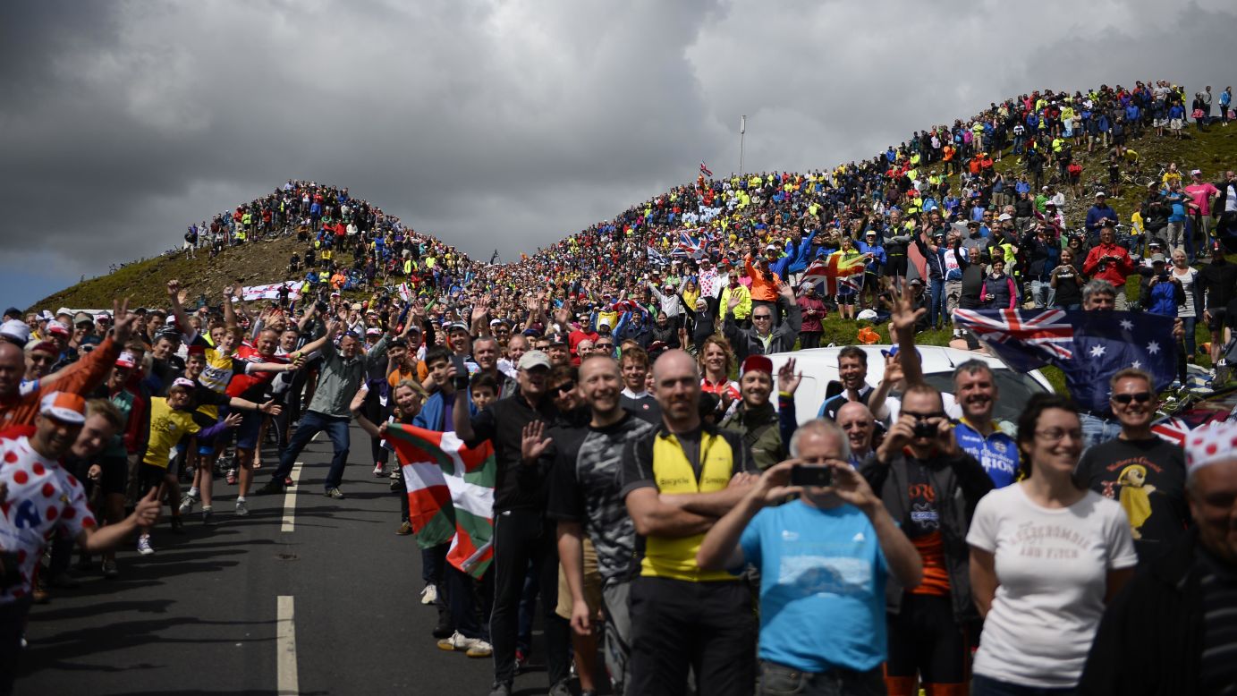 Cycling spectators are seen along a road in England during the first stage of the Tour de France on Saturday, July 5. The legendary road race began in Leeds, England, and will end in Paris on July 27.