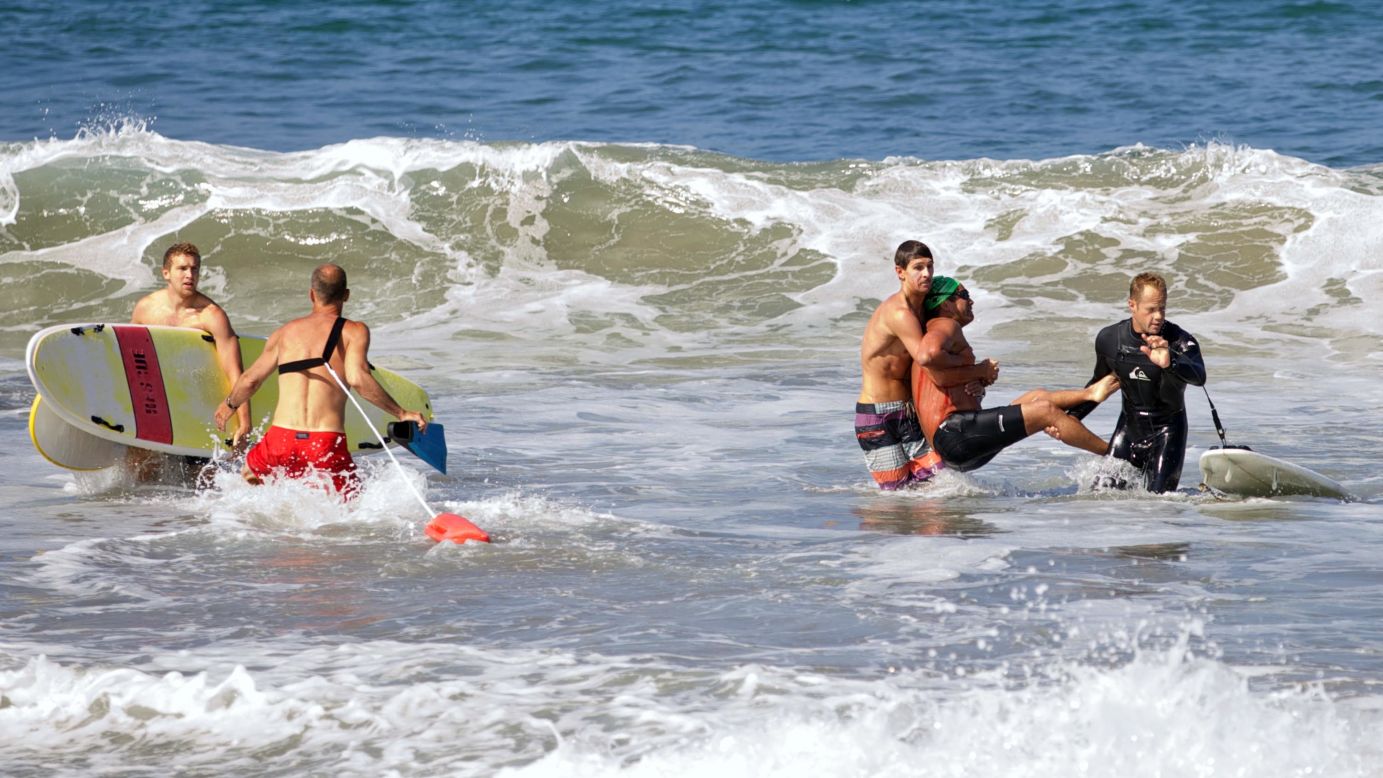 Two men carry Steven Robles after Robles was <a href="http://www.cnn.com/2014/07/07/us/california-shark-attack/index.html">attacked by a great white shark</a> Saturday, July 5, near Manhattan Beach, California. The 7-foot-long shark became agitated by a fisherman's hook and apparently took out its frustration on Robles, who was swimming nearby. "It did a sharp left turn and then it lunged right at me," said Robles, a long-distance swimmer. He is recovering from his wounds, but he said he might never swim in the open water again.