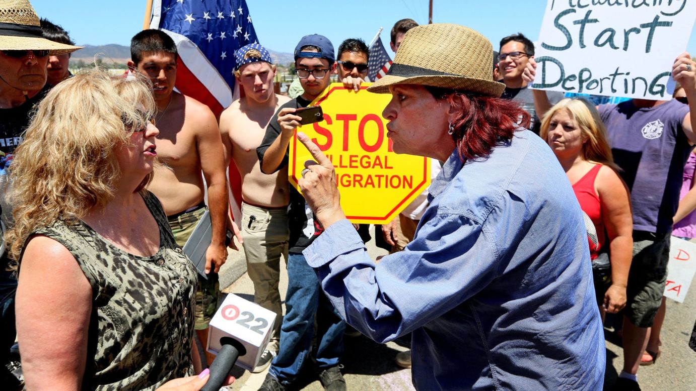 Activist Sabina Durden, right, debates Mary Estrada during an immigration protest Monday, July 7, outside of the U.S. Border Patrol station in Murrieta, California. Protesters have been staging rallies there in response to a wave of undocumented immigrant children who, after being caught along the U.S.-Mexico border in Texas, were transported to Murrieta to await their deportation proceedings.