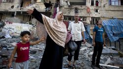 A Palestinian family leaves its house after it was damaged in an Israeli air strike on July 10, 2014 in Gaza City. The Israeli air force overnight hit more than 300 Hamas targets in the Gaza Strip in response to rocket fire from the besieged Palestinian territory, an army spokesman said. AFP PHOTO / MOHAMMED ABEDMOHAMMED ABED/AFP/Getty Images