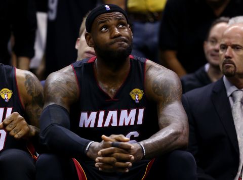 James reacts on the bench during the NBA Finals in June 2014. Later that month, he became a free agent.
