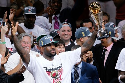 James celebrates with the NBA Finals Most Valuable Player trophy after the Heat defeated the Oklahoma City Thunder to win the NBA title in June 2012.