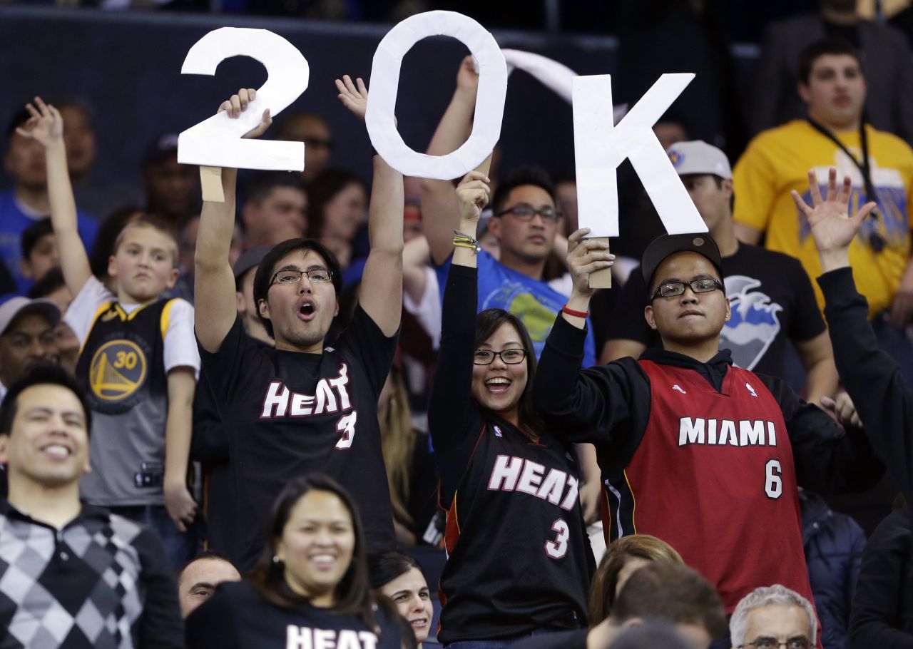 Fans hold a sign commemorating James' 20,000th career point, which he scored in January 2013 against the Golden State Warriors in Oakland, California.