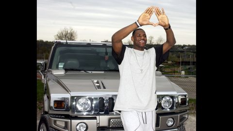 James poses in front of a Hummer after a news conference at St. Vincent-St. Mary High School in April 2003.