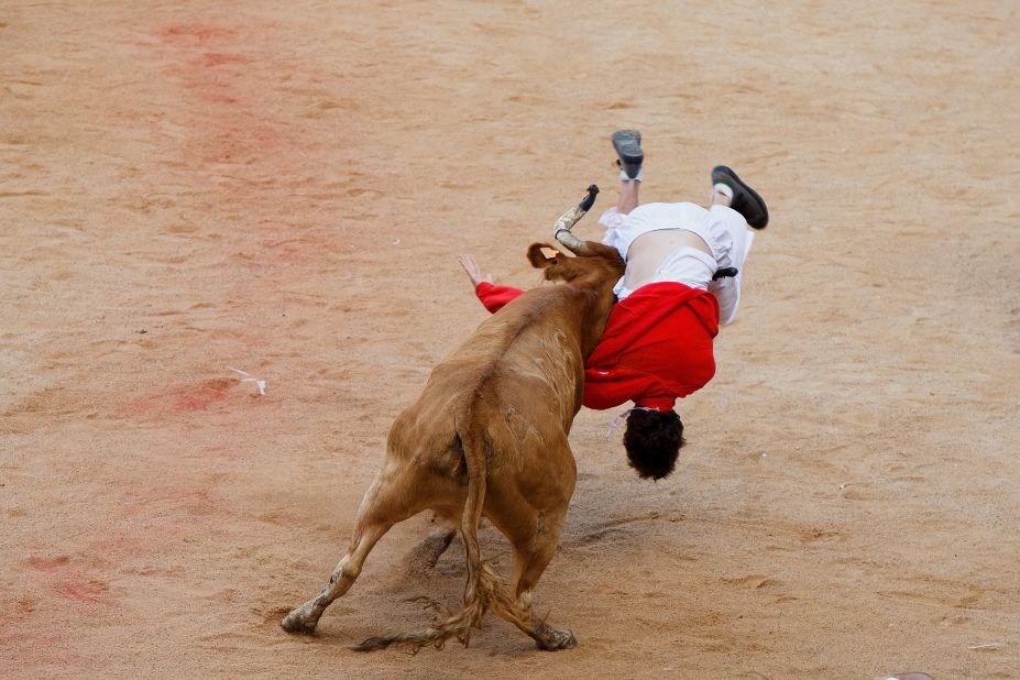 A bull lifts a reveler on July 11. 