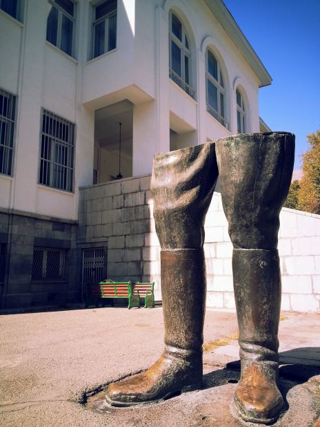 Outside the Shah's palace, only the legs remain of his colossal statue that was toppled during the 1979 Islamic Revolution.