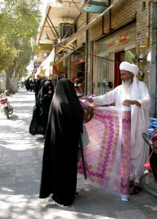 Salesmen ply their trade in the dusty streets of Yazd. Surrounded by desert in the center of the country, Yazd is renowned for its exquisite handicrafts.