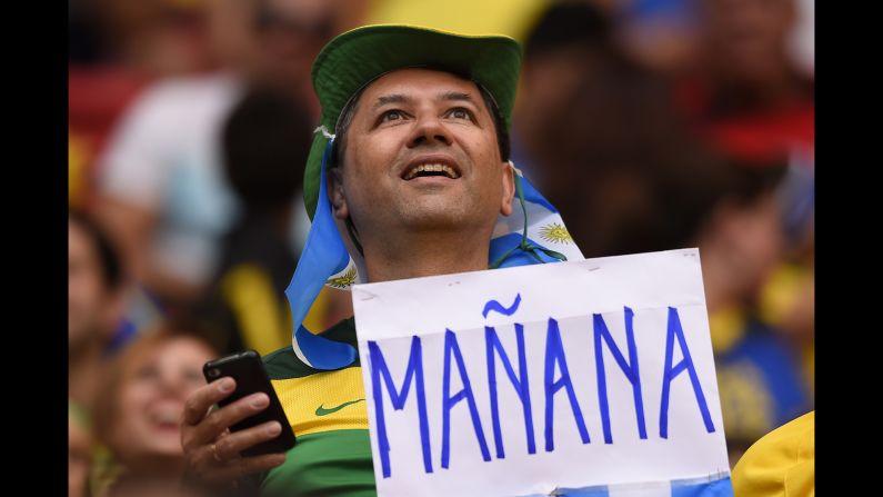 An Argentine fan holds a sign reading "tomorrow."