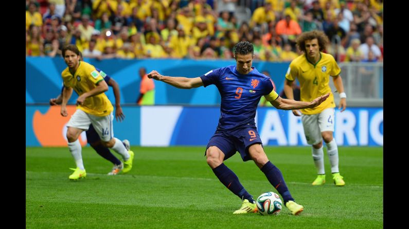 Robin van Persie of the Netherlands shoots and scores the first goal of the third-place match.