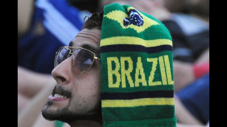 A fan of Brazil watches the third-place match between Brazil and the Netherlands on a screen at Copacabana Beach in Rio de Janeiro on Saturday, July 12. The Netherlands defeated Brazil 3-0. 